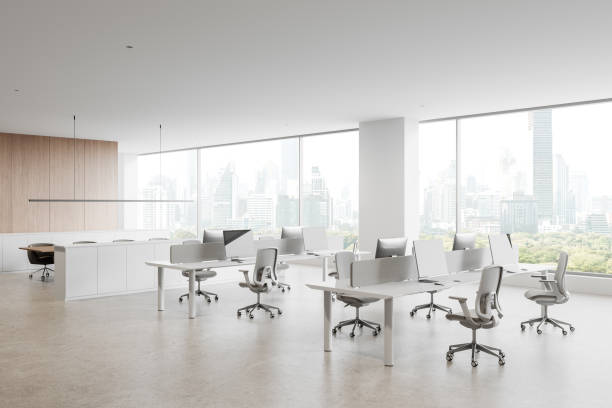 istock Modern office interior with minimalist design and open workspace overlooking urban skyline through large glass windows. 3D Rendering 2204288501