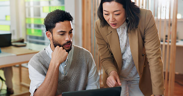 istock Business people, teamwork and advice on laptop for event planning, project proposal and reservation for venue. Man, woman and manager for discussion, website research or online booking brainstorming 2204289597