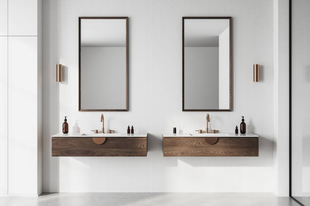 istock Modern bathroom interior with dual sinks and wooden vanities. 3D Rendering 2204290040