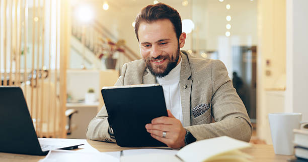 istock Research, planning and man with tablet, happy and schedule for interview, recruiter and reading of email. Corporate, online and smile for hiring process, browsing and app for communication in office 2204290960