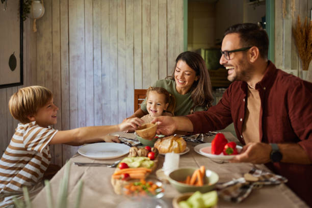istock Happy family talking while having a meal in dining room. 2204291889