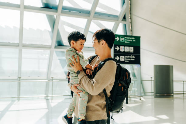 istock Caring father holding his son while waiting for their flight at the airport 2204292363