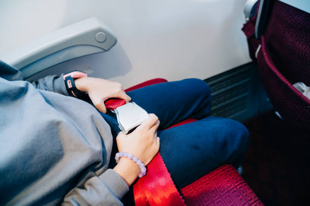 Close-up of an airplane seat belt ready for use by a passenger.