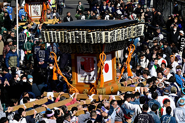 Akita, Japan - August 5, 2024: Young women play taiko drums and flutes on a festival float during the Akita Kanto Festival. The crowd cheered and added to the festive atmosphere.