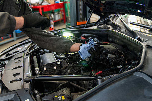 istock Serviceman checks the oil level in a car engine. 2204293097