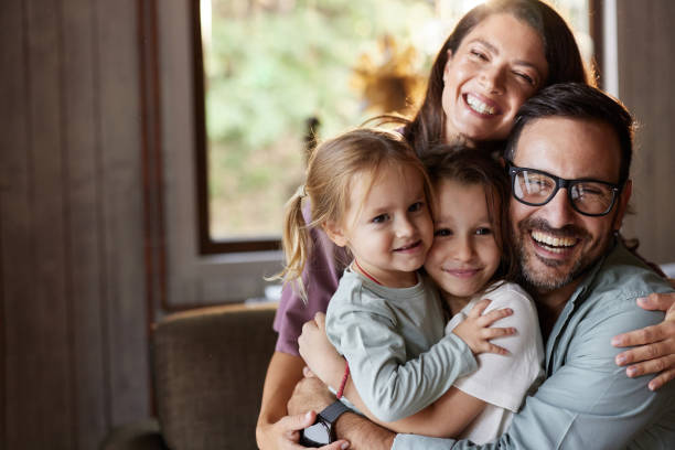 istock Happy family embracing at home. 2204294222