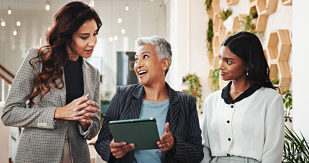 istock Business, people and talking with tablet for communication, planning event and schedule update. Women, discussion and digital with online reservation, brainstorming and venue information for proposal 2204296857