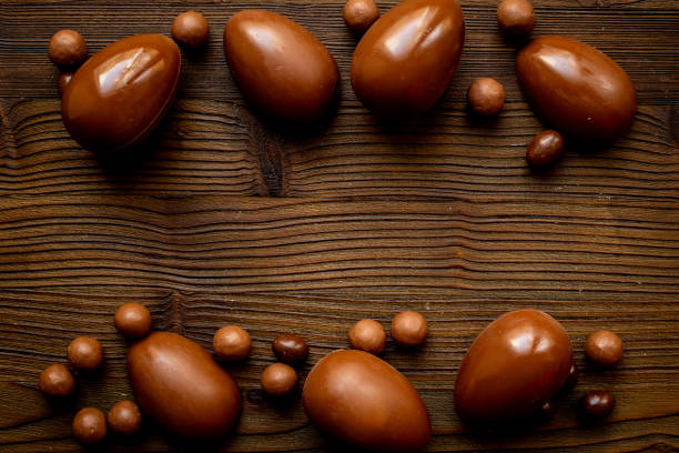 istock Frame of chocolate eggs and candies, top view. Chocolate background 2204300995