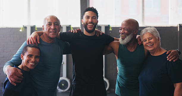 istock Mature people, personal trainer and portrait in gym class for exercise, workout or training. Physical therapy, support and help with laugh for fitness, coach and wellness for retirement health 2204301375