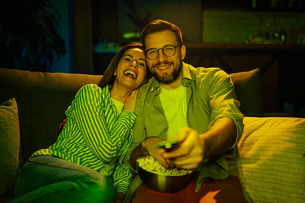 istock Couple enjoying movie night with popcorn 2204305339