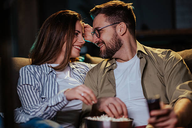 istock Couple enjoying movie night with popcorn 2204305362