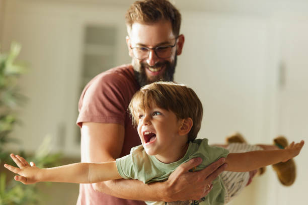istock Playful father having fun with his small son at home. 2204305732
