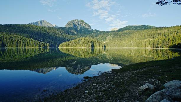 istock A serene mountain landscape with a reflective lake inviting exploration and adventure 2204305774