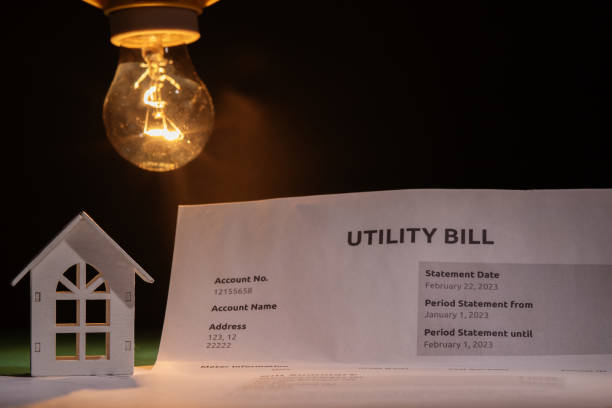 istock Utility bill and a house with a burning lightbulb, financial statement with cost breakdown, utility charges for electric power and heat, monthly budget planning 2204308239