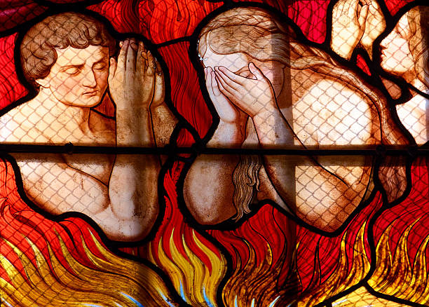 Basilique Notre Dame - Dole, France -  February 14, 2025: Stained (19th century) glass of souls from purgatory.