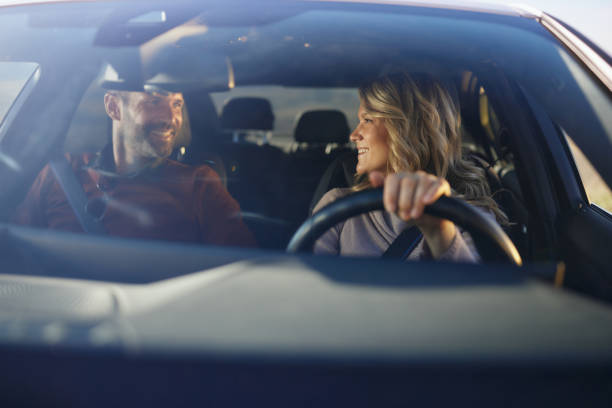 istock Happy couple talking during their road trip by car. 2204308705