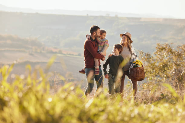 istock Happy family talking while going on a picnic in autumn day. 2204308728