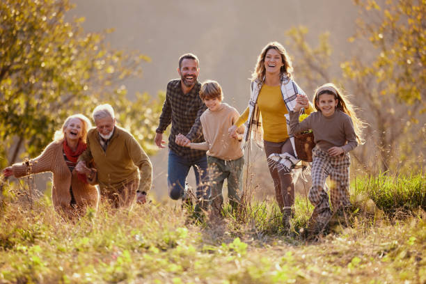 istock Happy extended family having fun while going on a picnic in autumn day. 2204308876