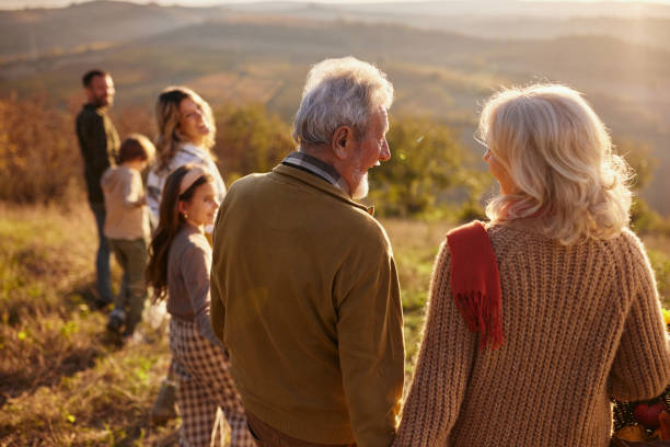 istock Back view of multi-generation family walking in autumn day. 2204309017