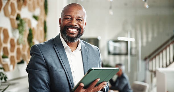 istock Businessman, financial advice and portrait with tablet, digital budget and report for customer portfolio. People, accountant or agent meeting with project consultation, review or audit assistance 2204309607