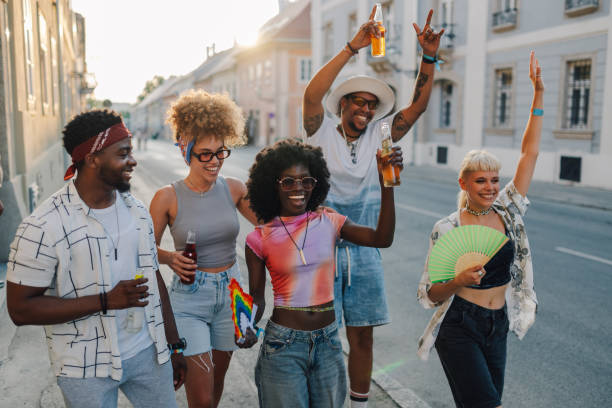 istock Friends celebrating at gay pride parade, drinking and having fun 2204310930