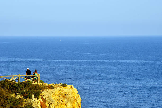 a couple walking on the path shot taken from the path with breathtaking views along the coast from the arcades to the Benagil caves Lagoa Algarve Portugal September 17, 2024 Lagoa Portugal