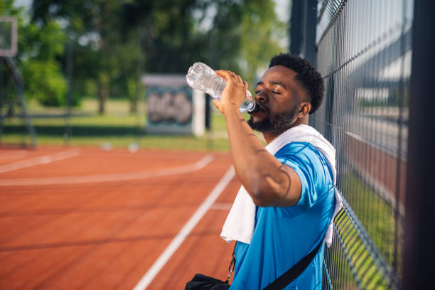 istock Young basketball player drinking water after training 2204312492