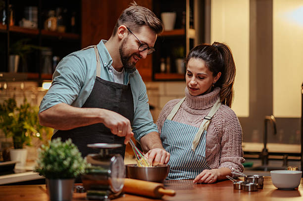 istock Couple enjoying cooking together in modern kitchen 2204312815