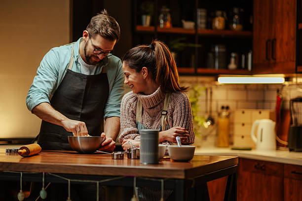 istock Couple enjoying cooking together in cozy kitchen 2204312818