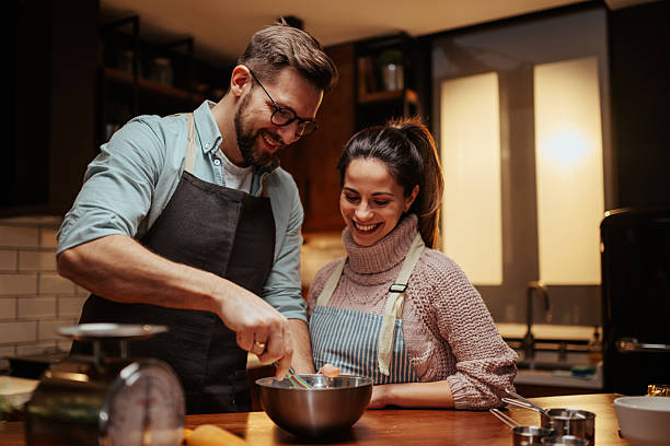 istock Couple enjoying cooking together in modern kitchen 2204312851