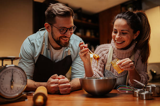 istock Couple enjoying a fun cooking activity together 2204312853