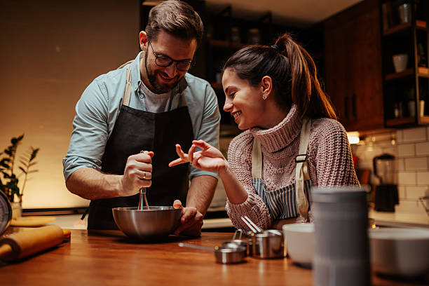 istock Couple enjoying baking together in cozy kitchen 2204312858