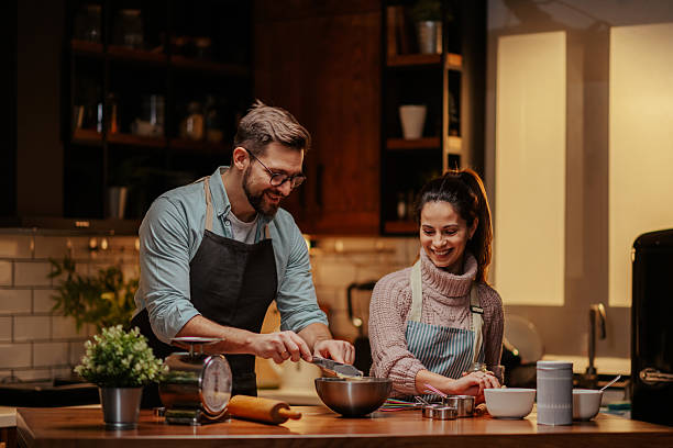 istock Couple enjoying cooking together in modern kitchen 2204312862