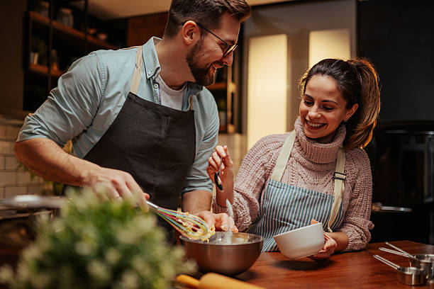 istock Couple enjoying a fun cooking activity together 2204312870