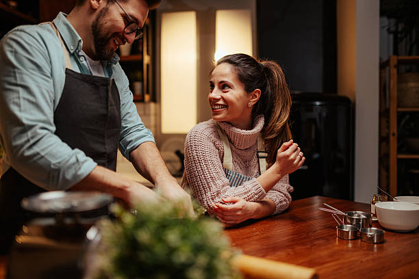 istock Smiling couple enjoying cooking together at home 2204312874
