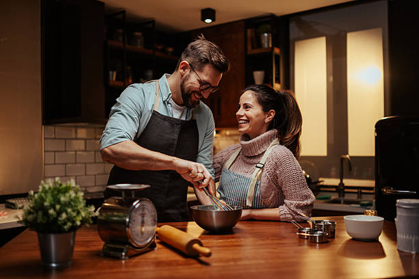 istock Couple enjoying cooking together in modern kitchen 2204312875
