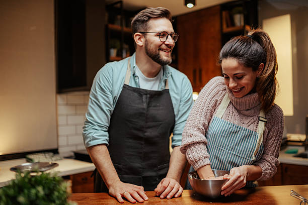 istock Couple enjoying cooking together in cozy kitchen 2204312877