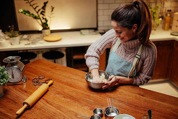 istock Young woman joyfully baking in a cozy kitchen 2204312885