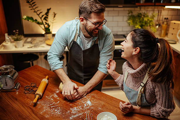 istock Happy couple baking together in cozy kitchen 2204312892