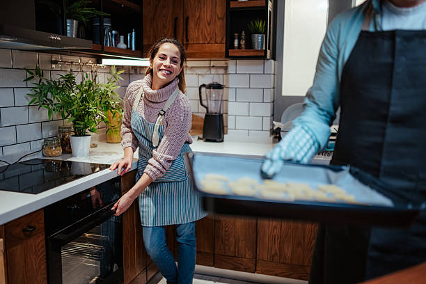 Smiling woman baking cookies in cozy kitchen