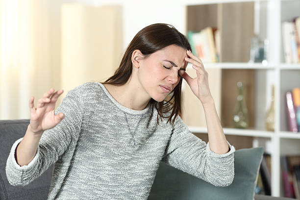 istock Dizzy woman at home ready to faint 2204314828
