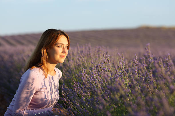 istock Relaxed woman sitting in lavender field at sunset 2204314841