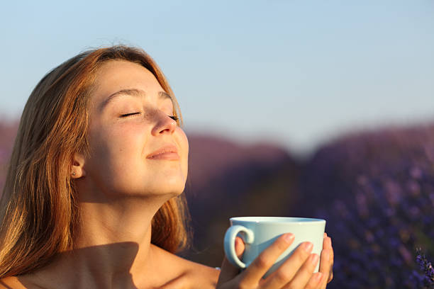 istock Woman breathing in lavender field drinking tea 2204315108