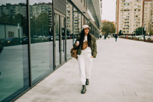 istock Stylish Woman Walking by Modern Building 2204315236