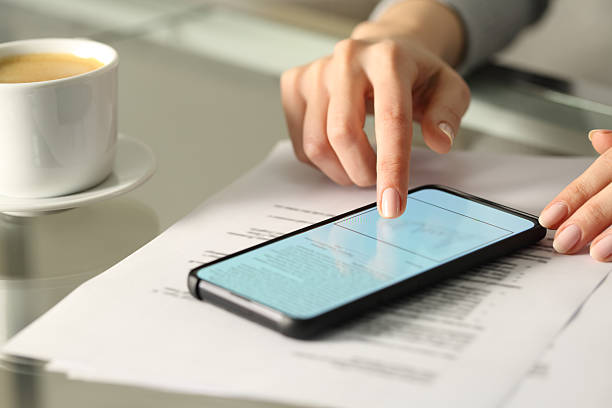 istock Woman hand signing online document with smart phone 2204317084