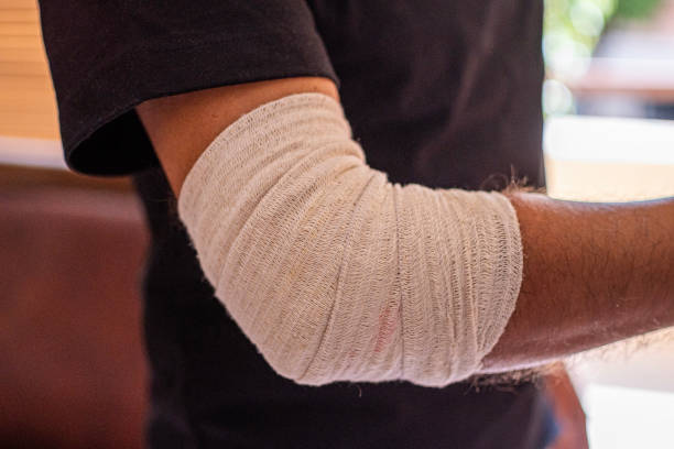 Man hand with elastic bandage on elbow