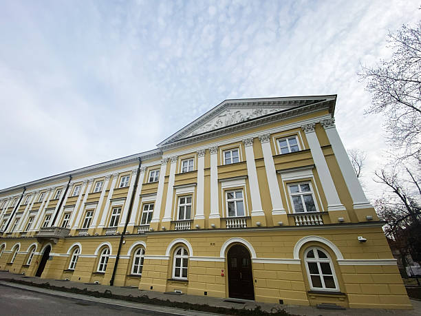Elegant historical building with classical architecture in Warsaw, Poland under a cloudy sky
