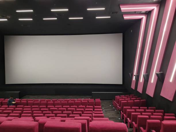 Empty Movie Theater with Red Seats and Blank Screen
