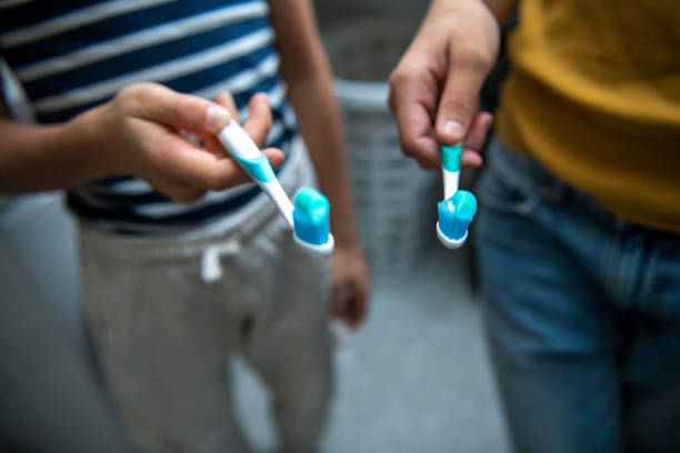 Kids holding toothbrush close up