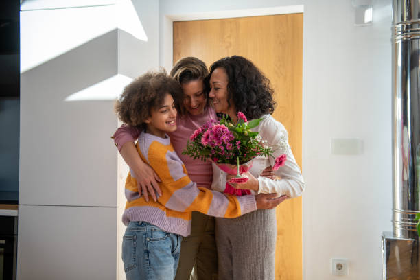 istock Two generation woman's hugging at home entrance 2204318838